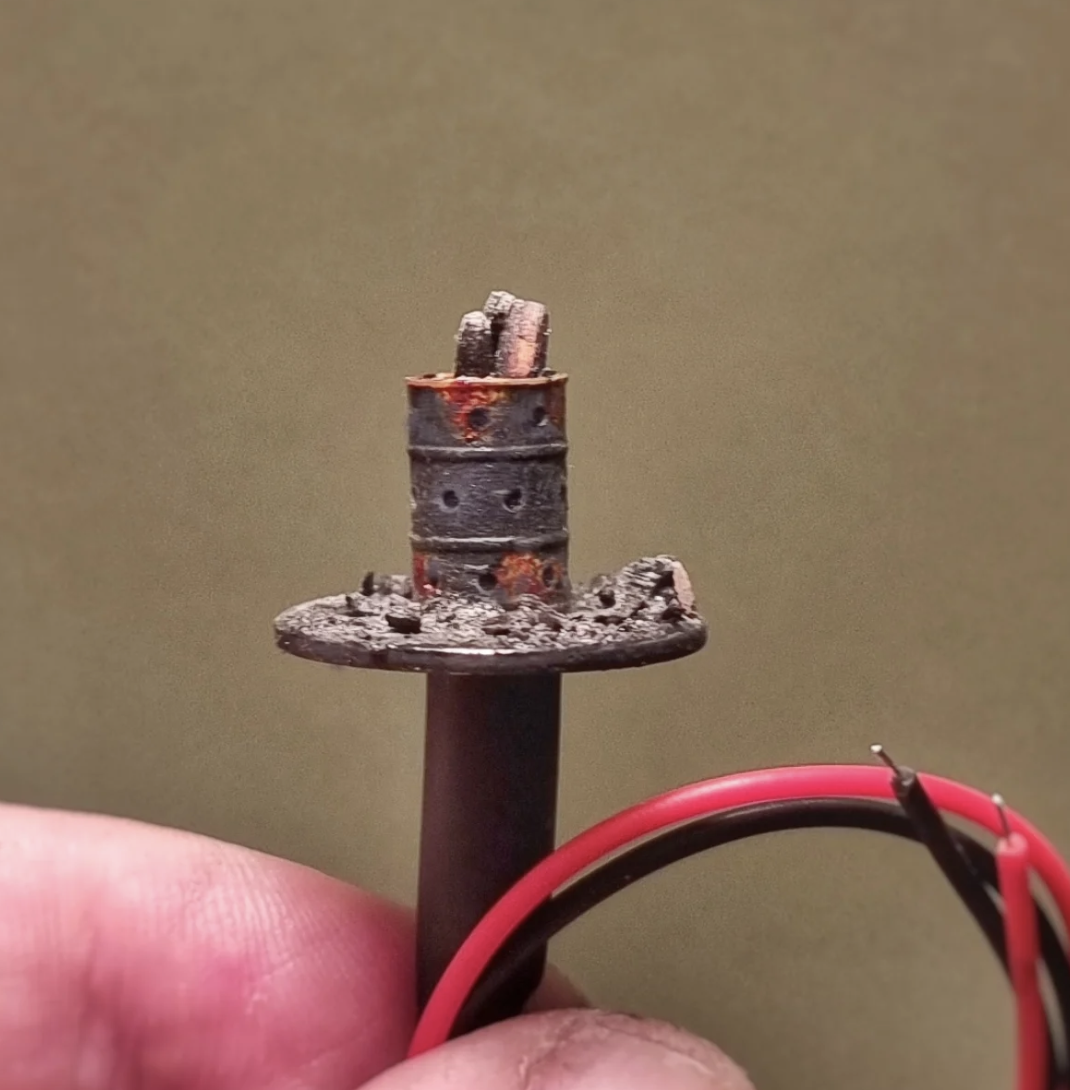 Rust and burnt timber on 1:76th scale model railway brazier